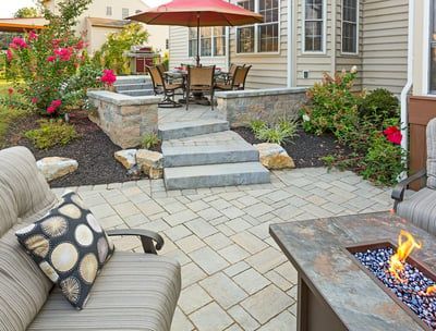 There is a fire pit in the middle of the patio.