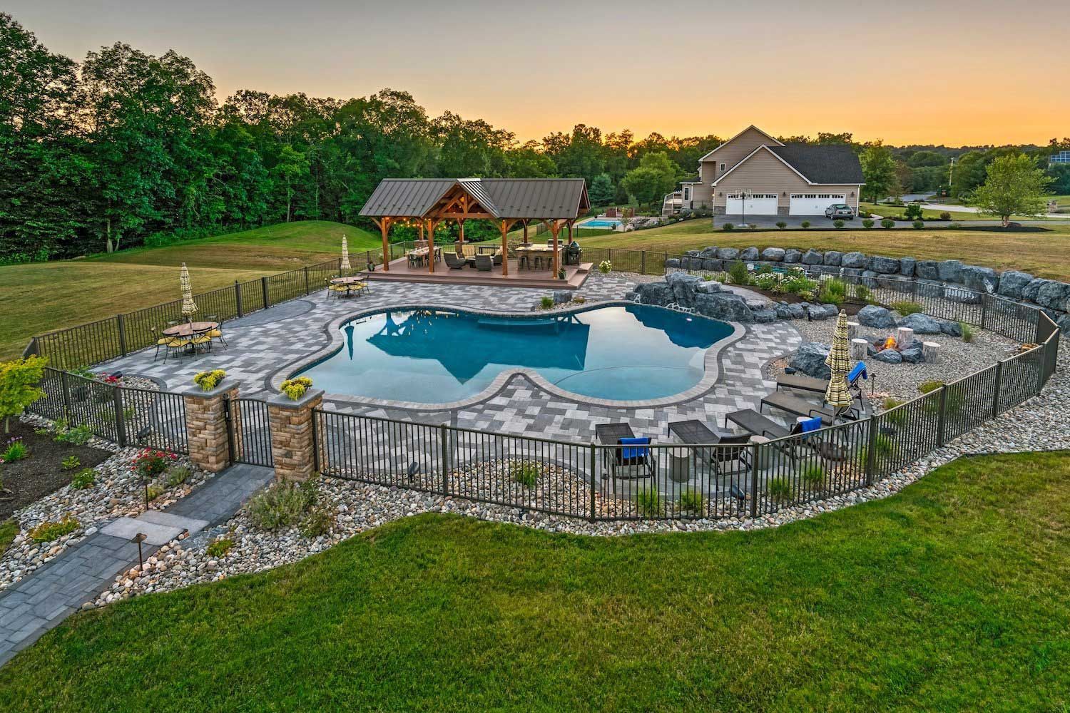 An aerial view of a large swimming pool surrounded by a stone fence.