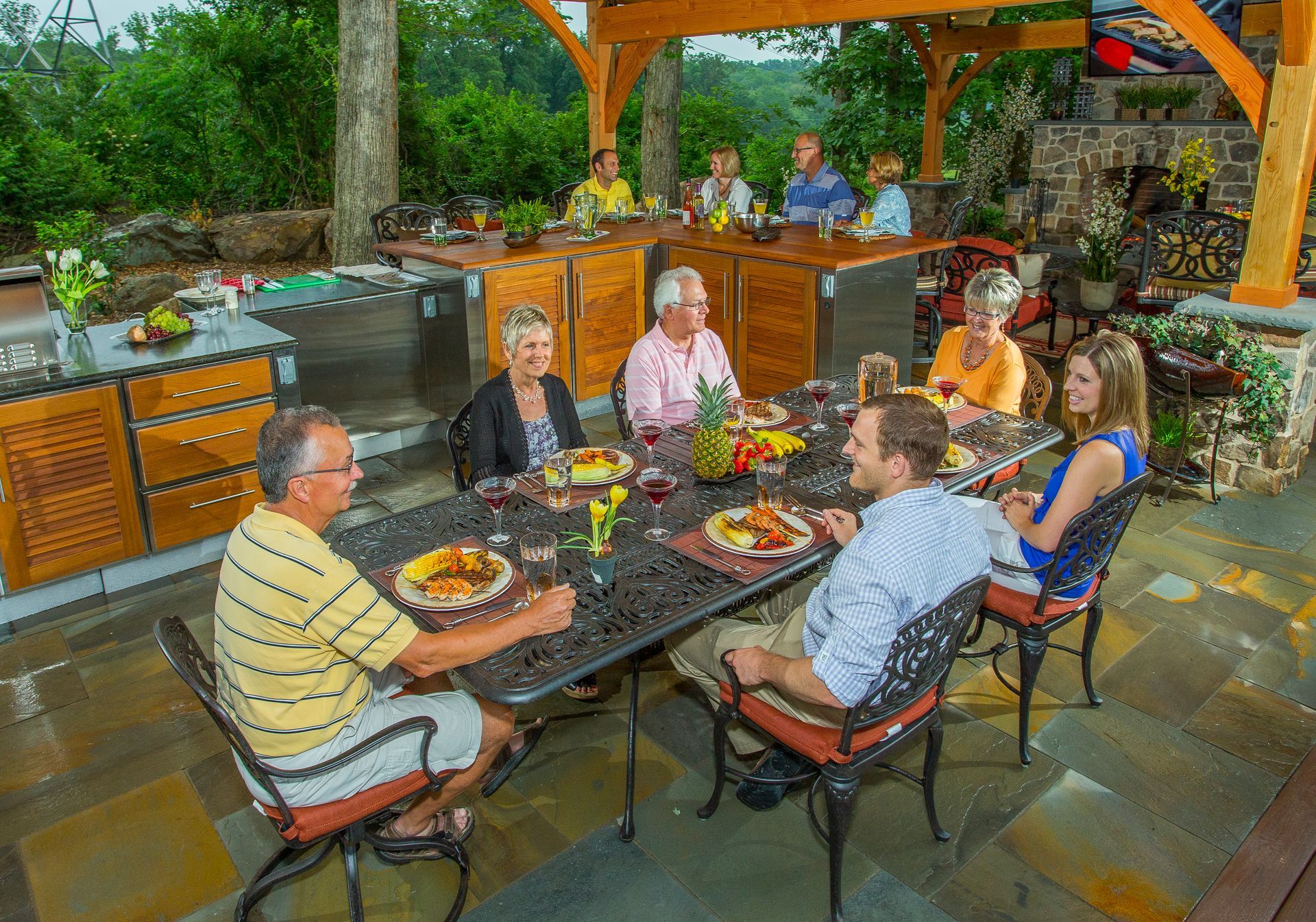 A group of people are sitting around a table eating food.