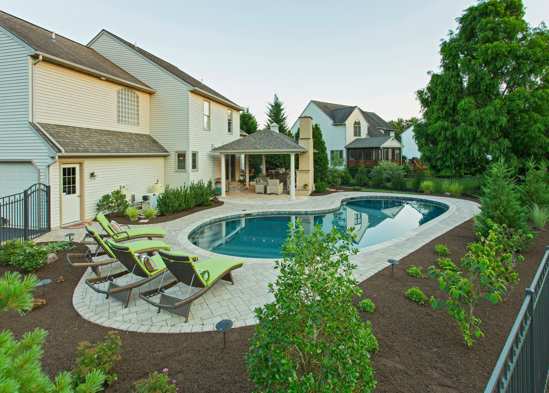 A large swimming pool in the backyard of a house