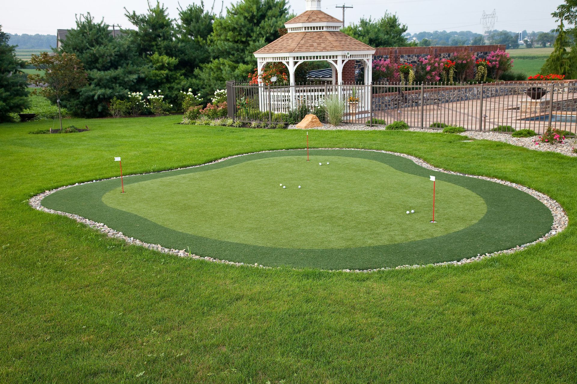 A golf course with a gazebo in the background