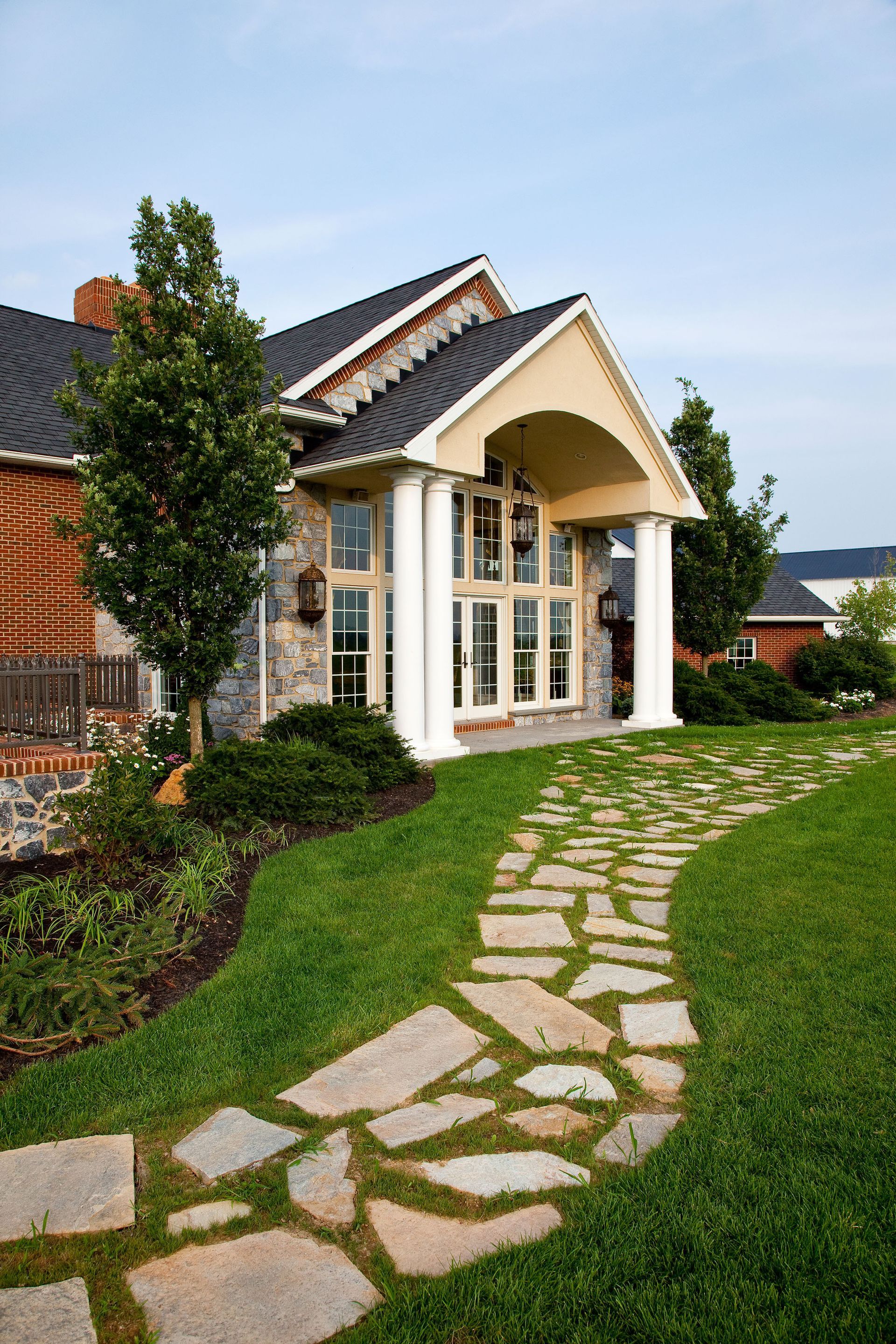 A house with a stone walkway leading to it