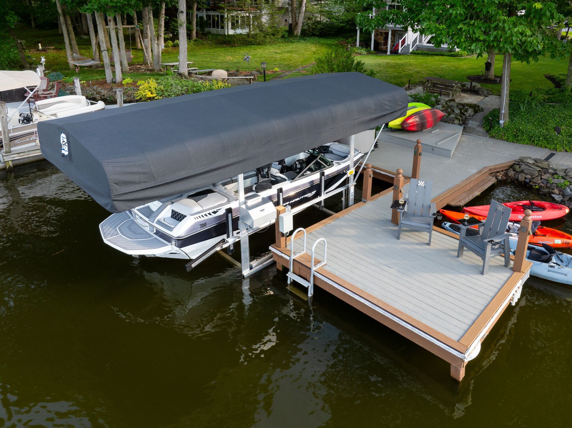A boat is docked at a dock with a canopy over it.