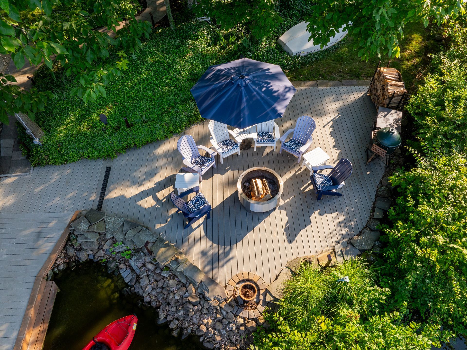 An aerial view of a patio with a fire pit and chairs.