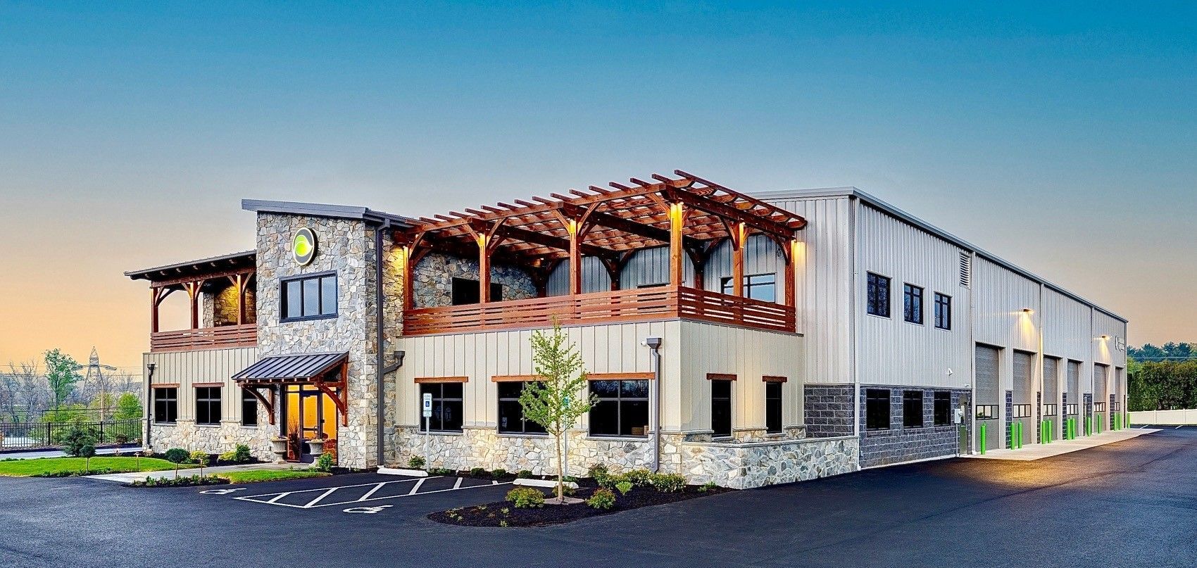 A large building with a lot of windows and a pergola on top of it.