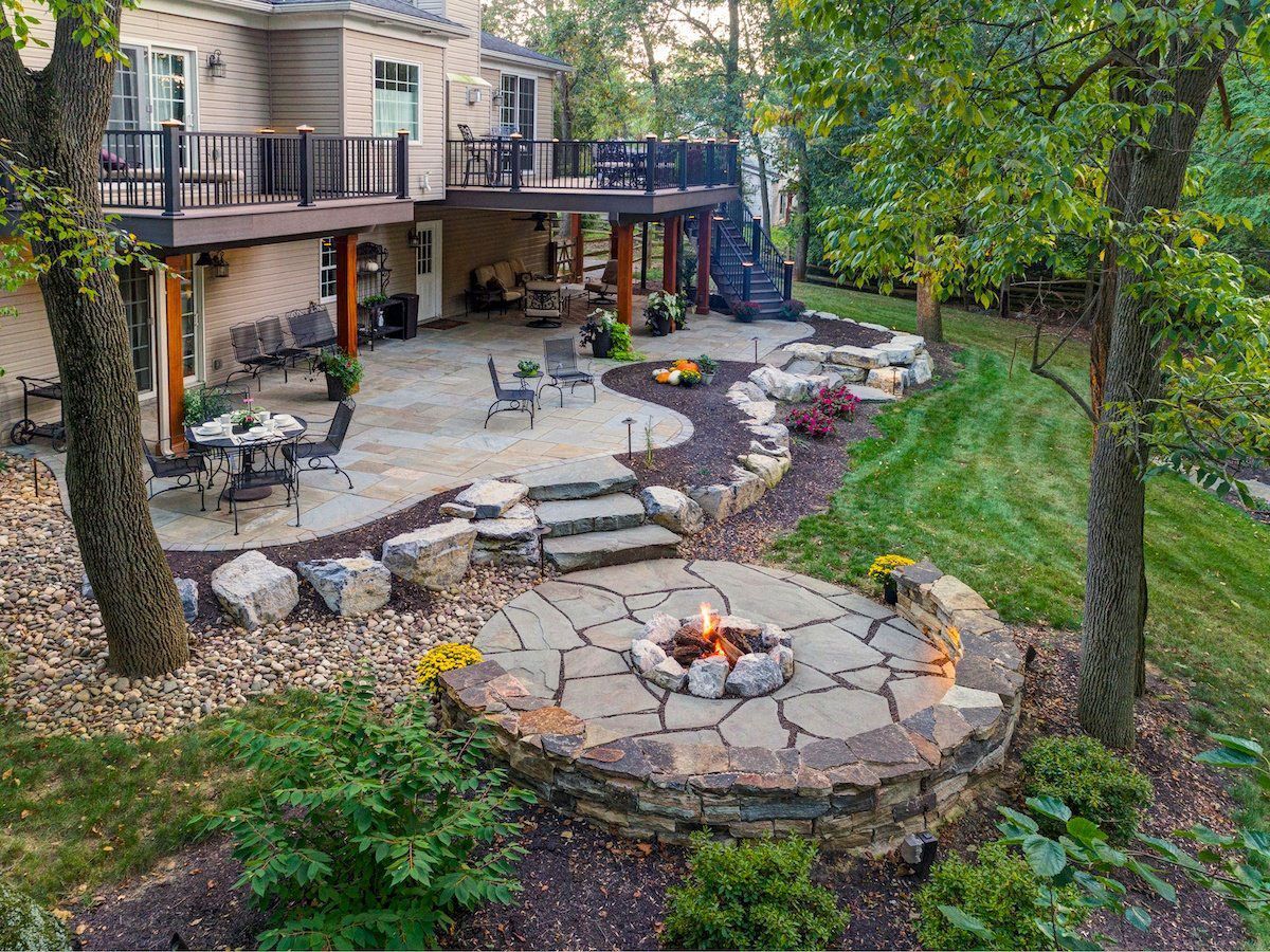 There is a fire pit in the middle of the backyard.