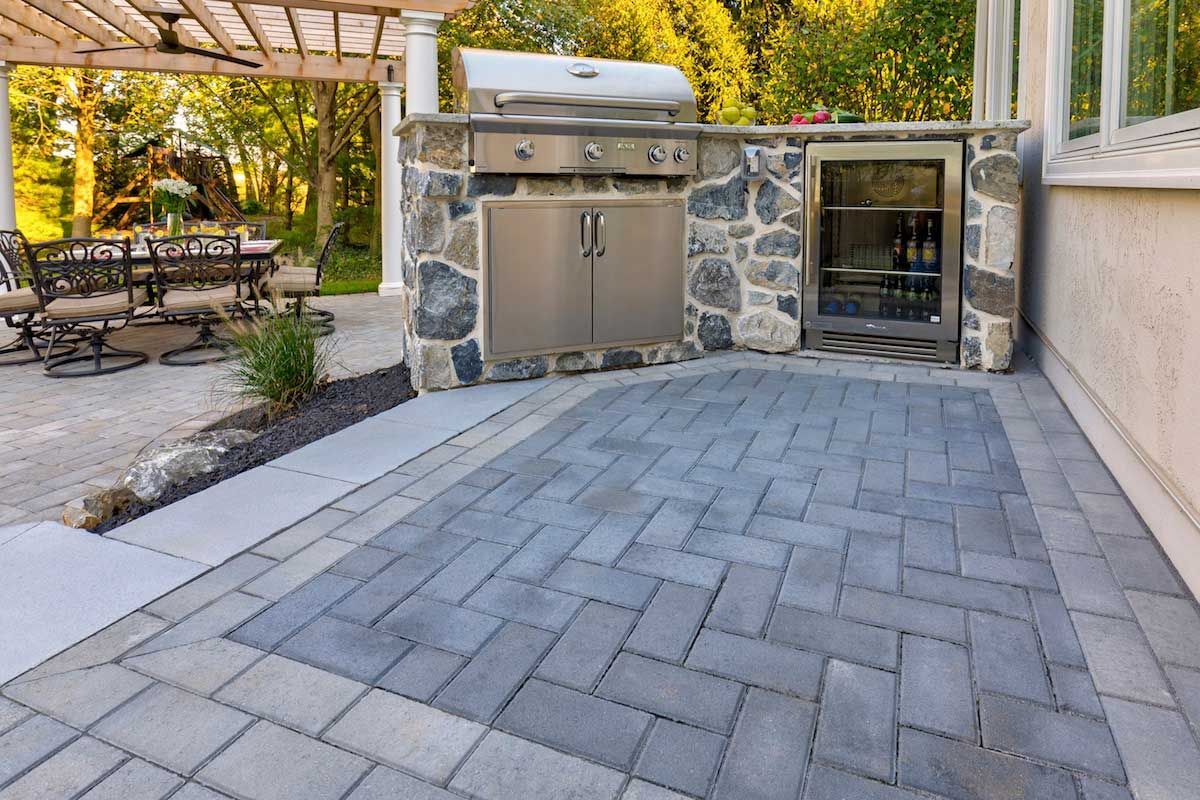 There is a grill in the middle of the patio.