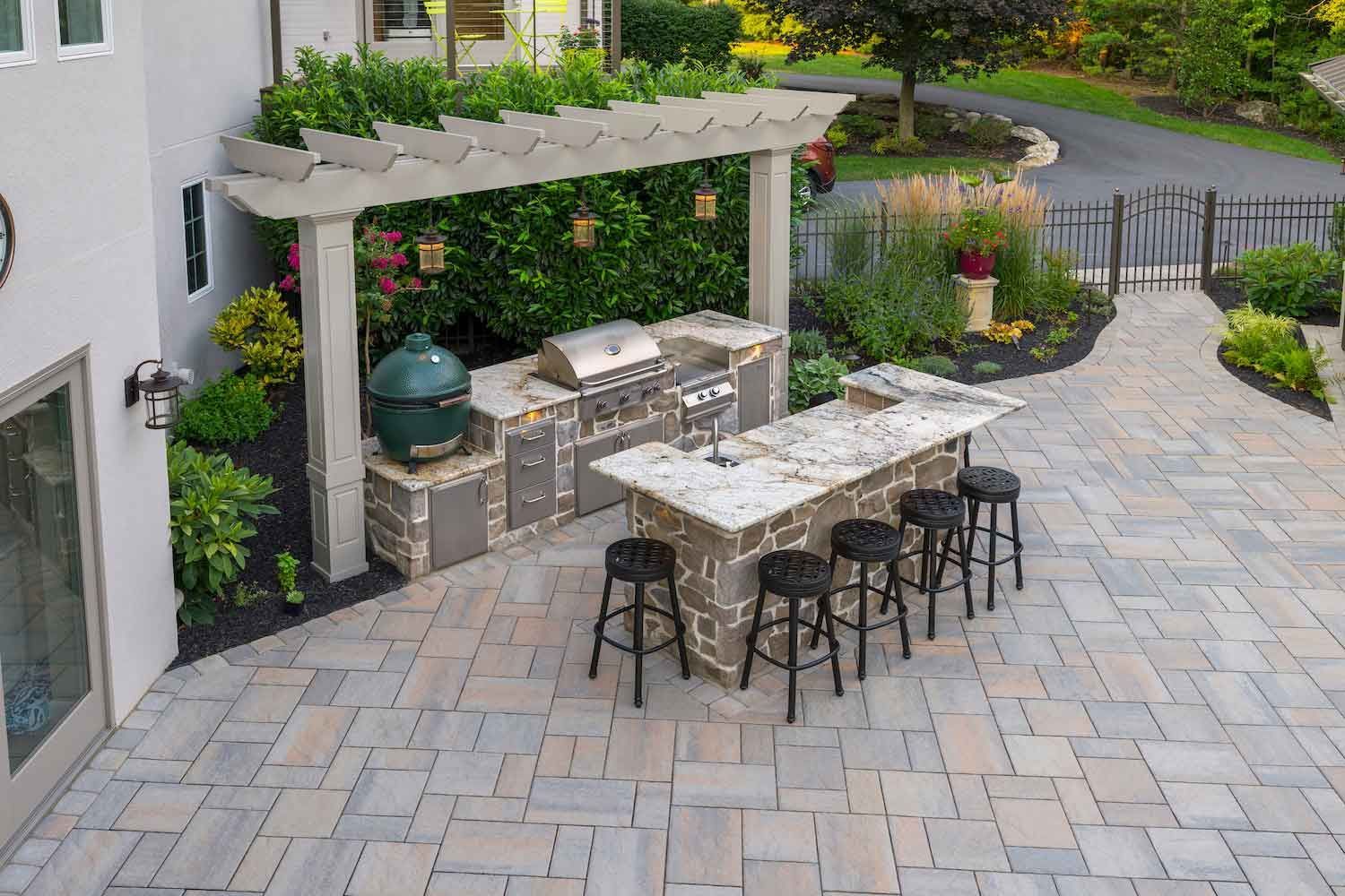 An aerial view of a patio with a kitchen and stools.