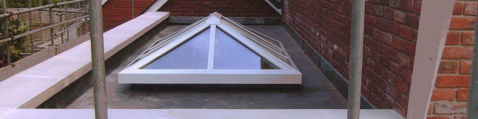 A roof with lead work and a velux window