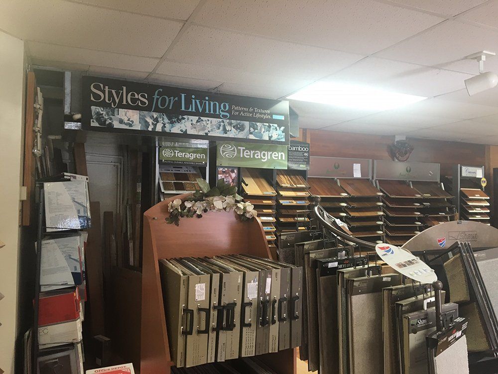 A store filled with lots of carpets and a sign that says styles for living.