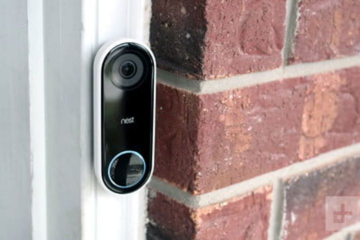 A nest doorbell is attached to a brick wall.