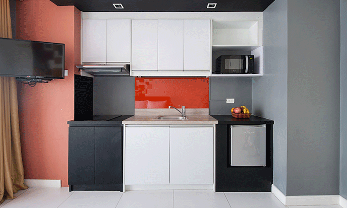 Studio deluxe kitchen area with microwave, mini fridge, stovetop at KL Tower