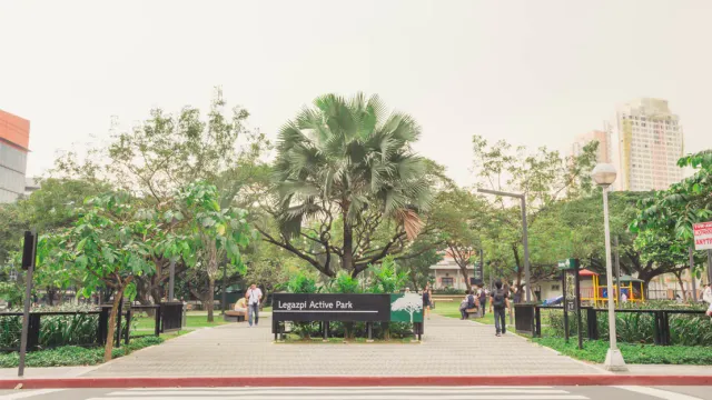 Lush garden pathway with palm trees surrounding hotels in Greenbelt Makati.