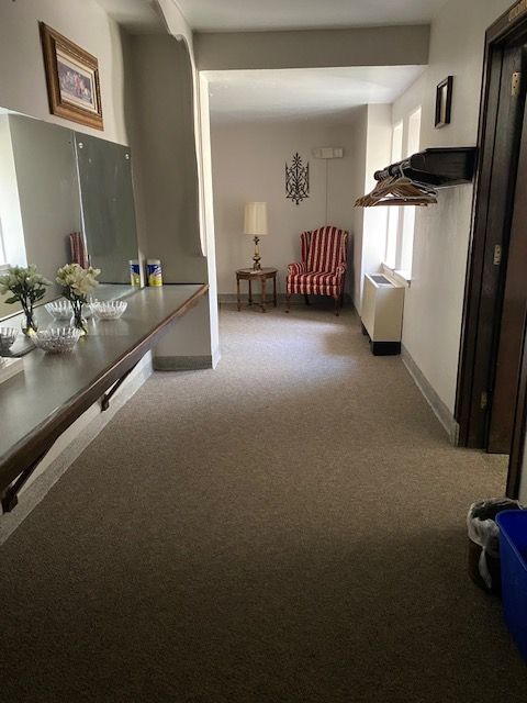 A hallway with a table and chairs in it