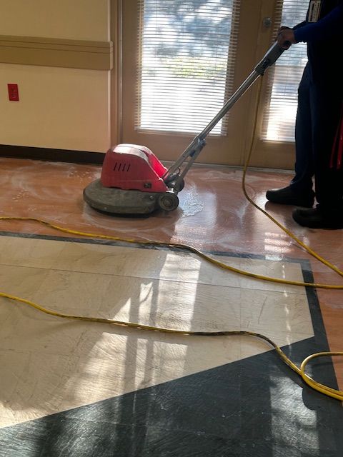 A person is using a machine to clean a tile floor