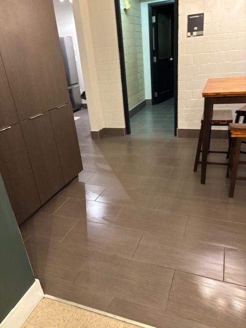 A kitchen with a wooden table and stools