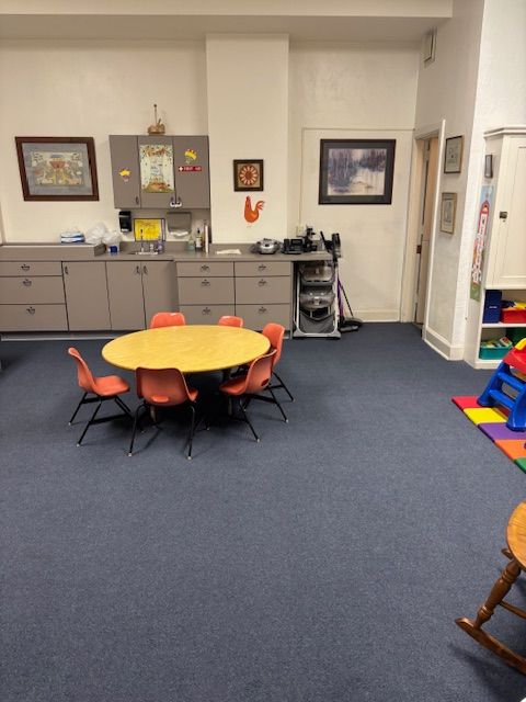 A room with a table and chairs in it