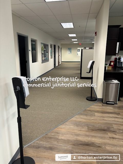 A long hallway with a hand sanitizer stand in the middle