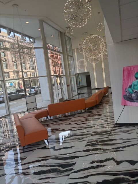 A room with a couch and a painting on the wall