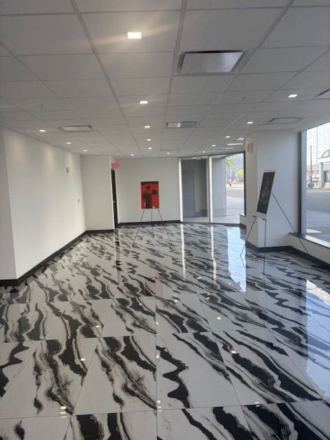 A large room with a marble floor and white walls