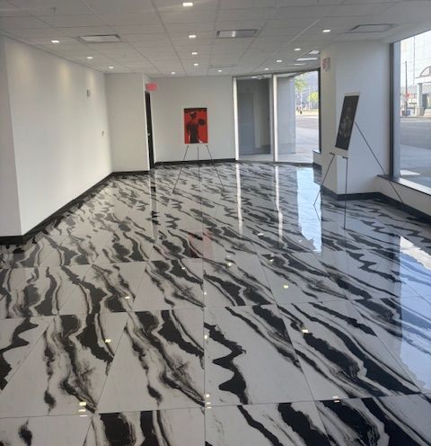 A large room with a black and white marble floor