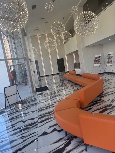 A large lobby with a couch and chairs in it