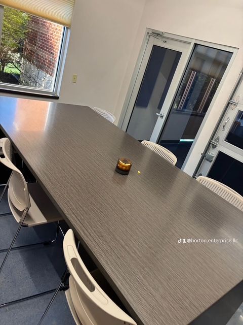 A conference room with a long table and chairs