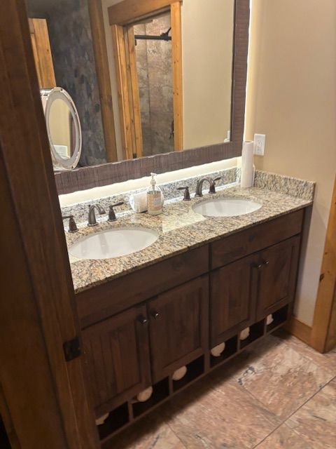 A bathroom with two sinks and a mirror.