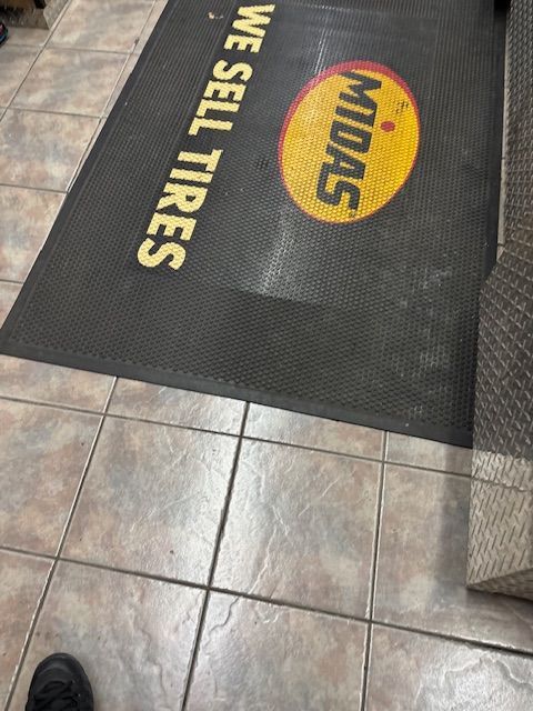 A black mat that says we sell tires on it