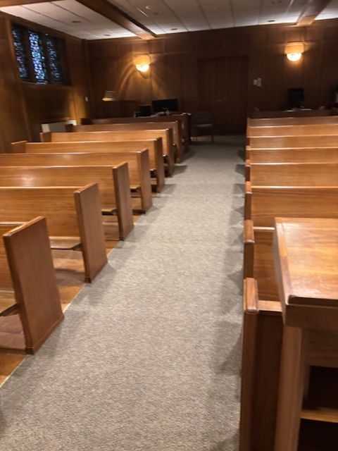 Rows of wooden benches in an empty church