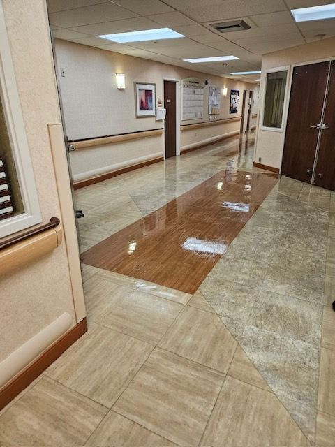 A hospital hallway with tile floors and wooden walls