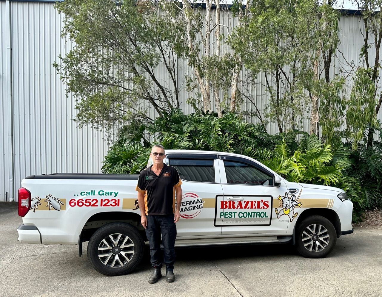 Pest Control Business Ute With Man Infront Of Vehicle —Brazel's Pest Control in Macksville, NSW
