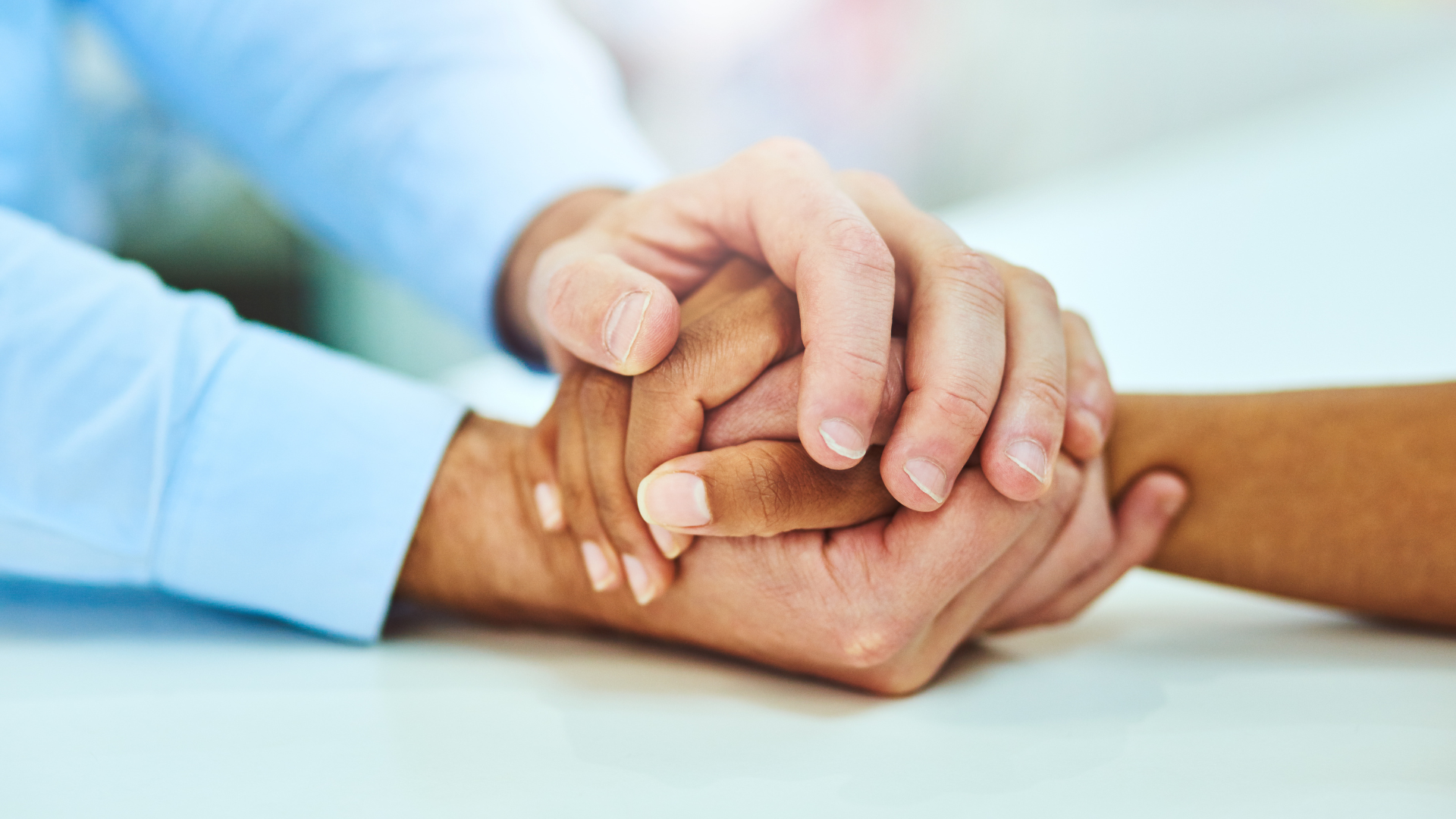 a group of people are putting their hands together in a circle