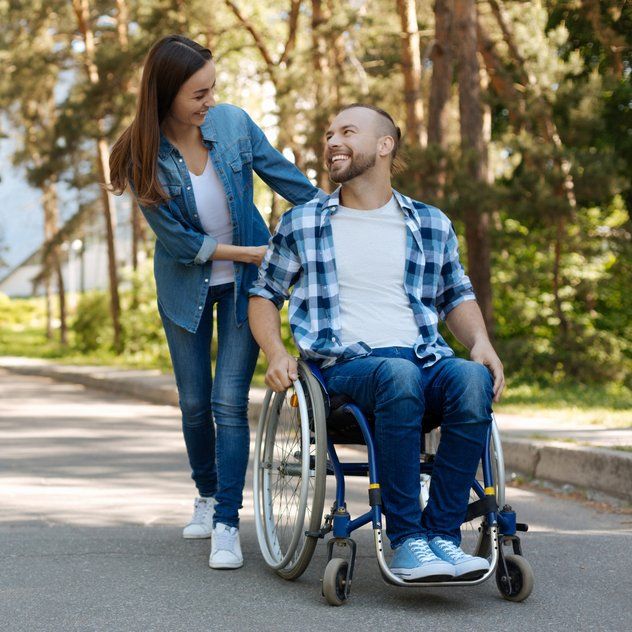 Man In Wheelchair with Female Volunteer — Aged Care Services in Paget, QLD