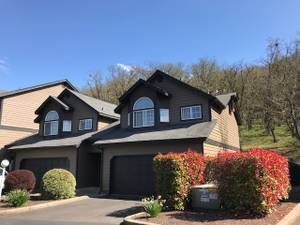 A couple of houses sitting next to each other on top of a hill.