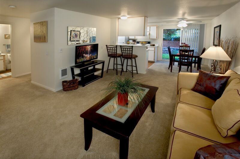 A living room with a couch a coffee table and a television