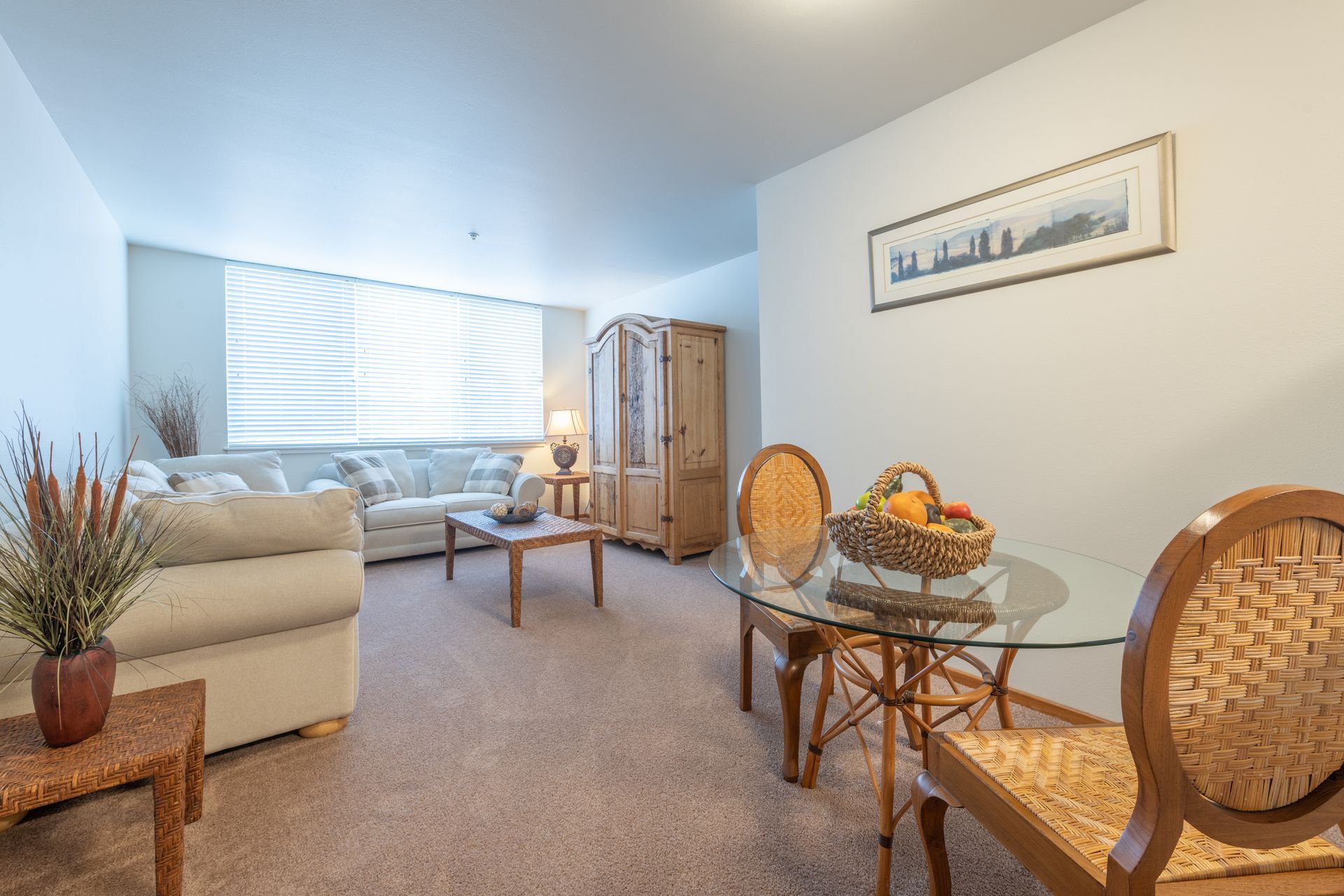 A living room with a dining table and chairs and a couch.