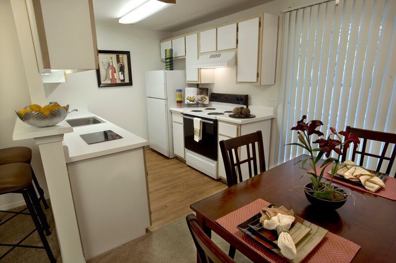 A kitchen with a table and chairs in it