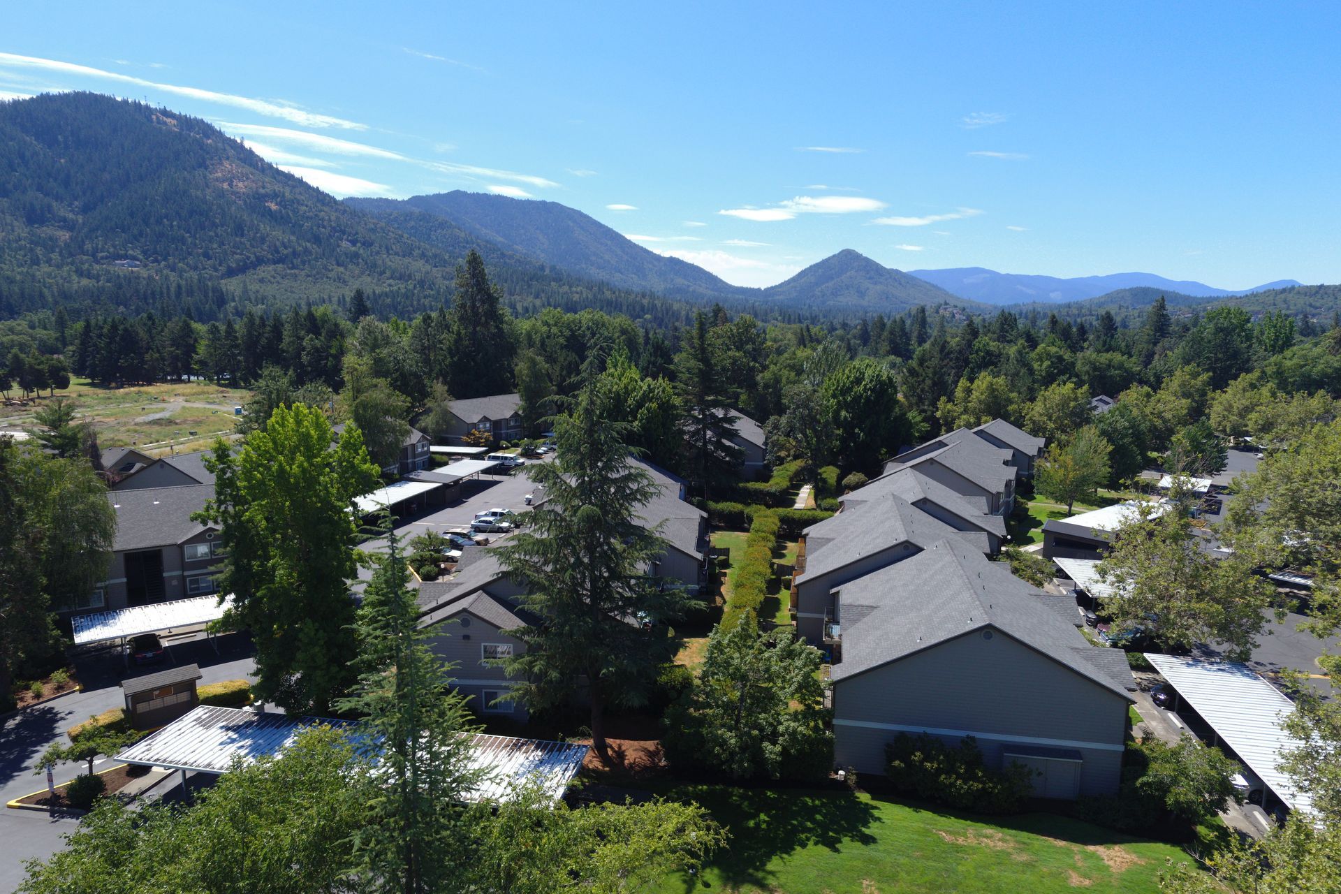 An aerial view of a residential area with mountains in the background