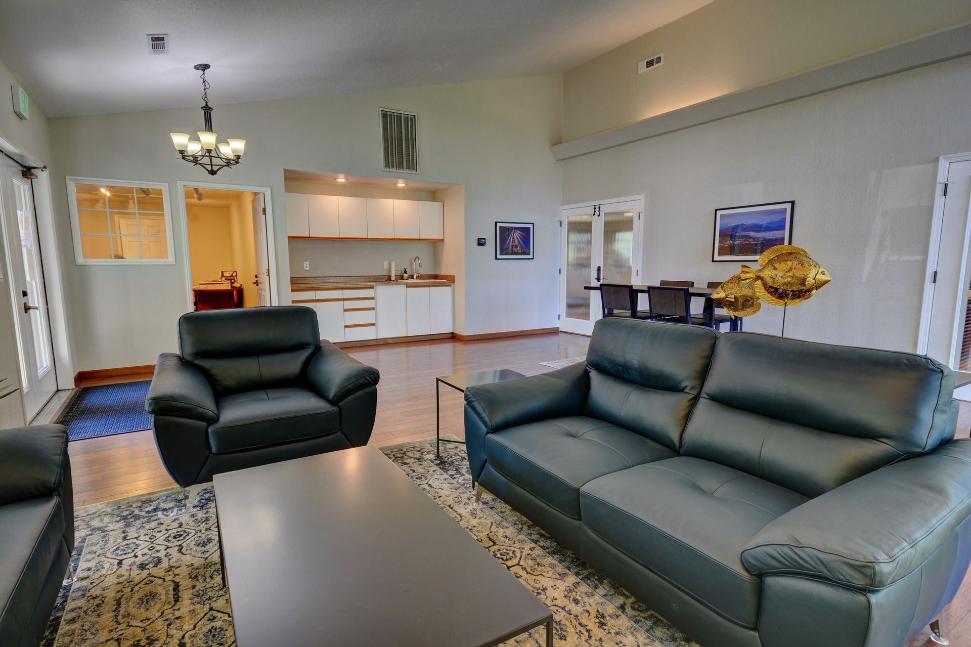 A living room with a couch and two chairs