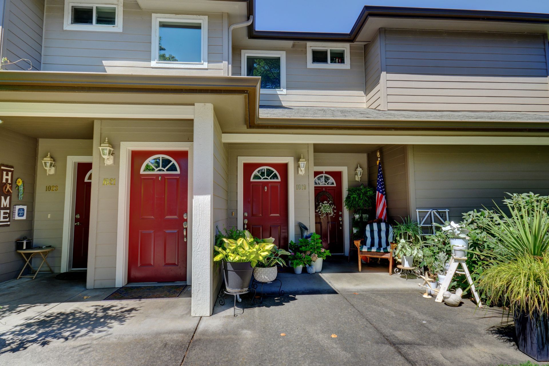 The front of a house with red doors and a porch