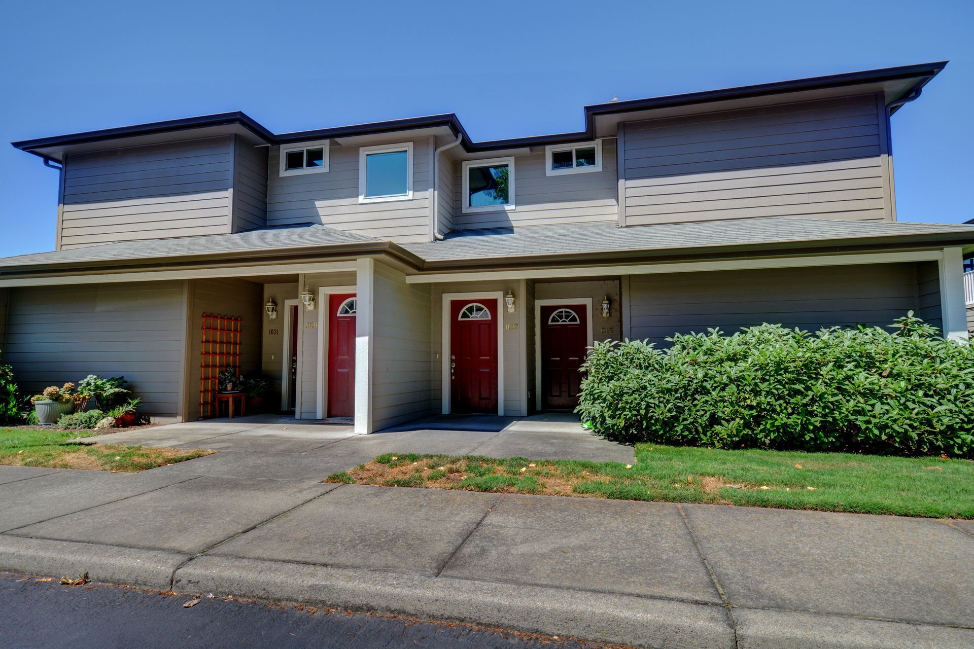 The front of a house with two red garage doors
