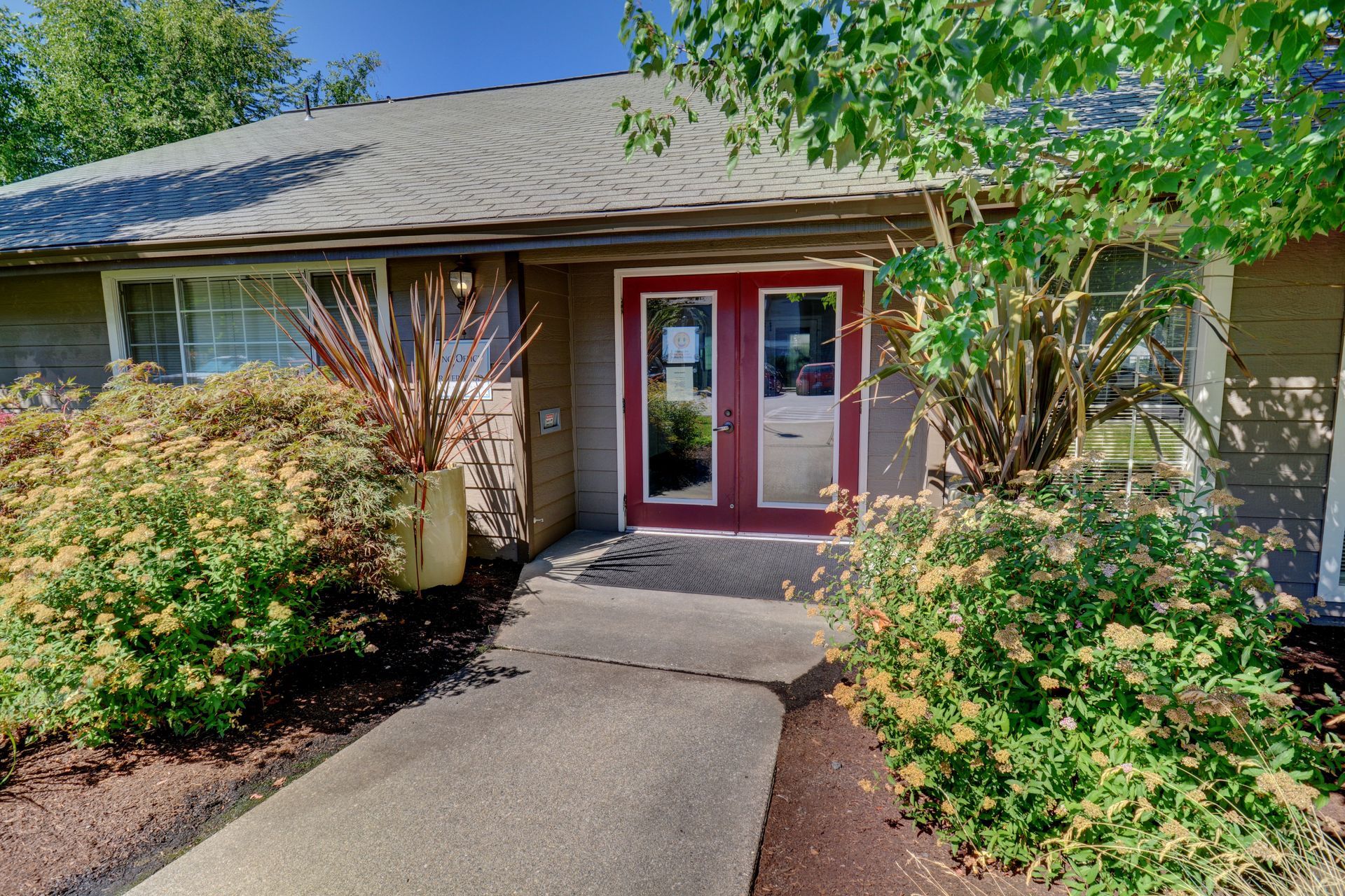 A house with a red door and a walkway leading to it