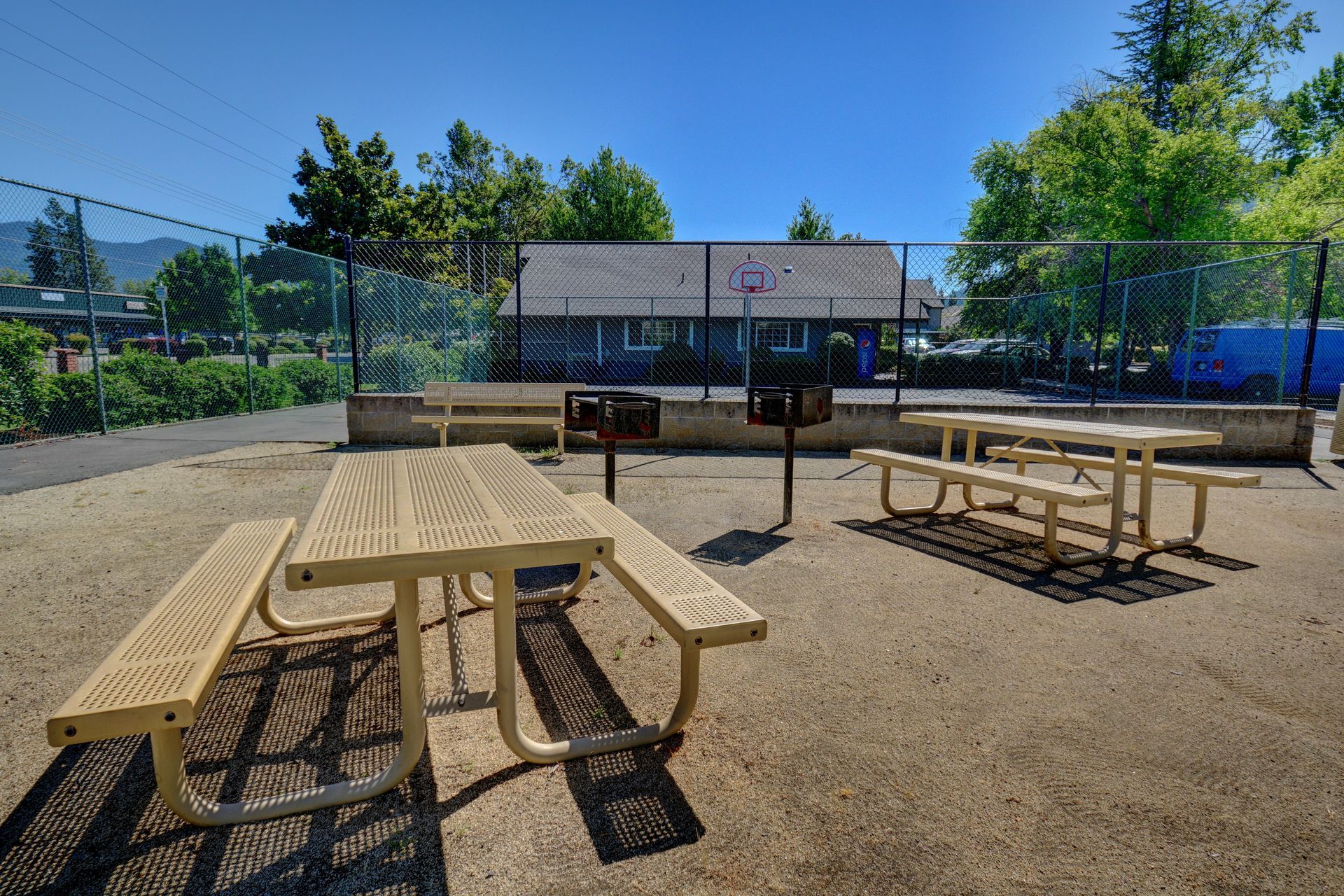 A picnic area with tables and grills in a park