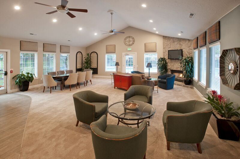 A large room with a lot of furniture and a ceiling fan.