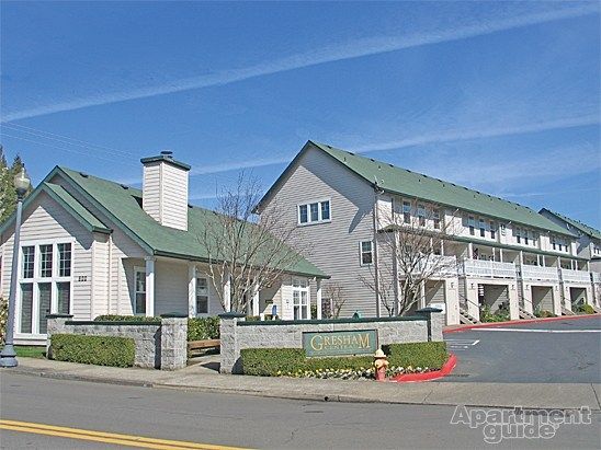 A white house with a green roof and a sign that says gateway