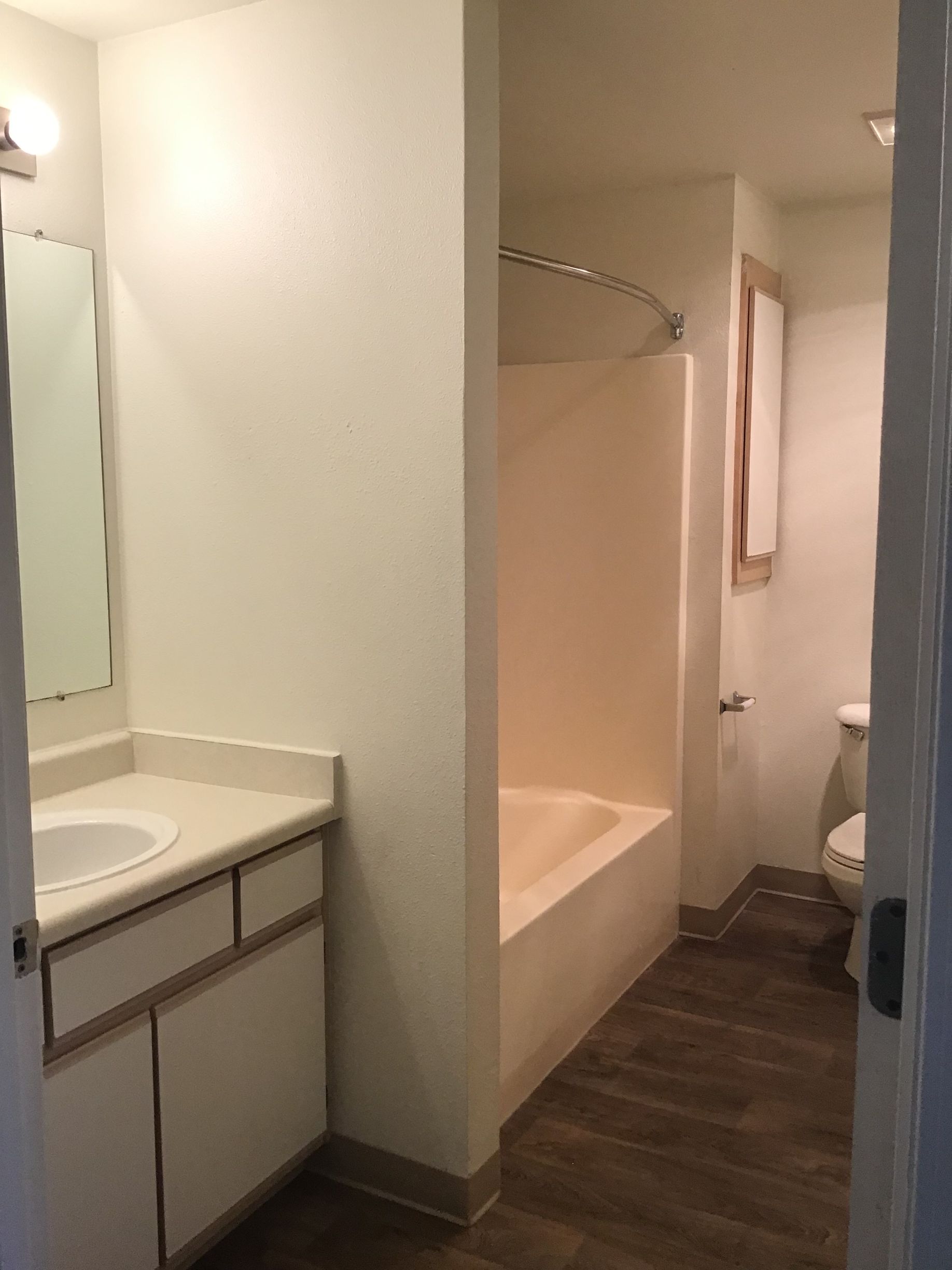 A bathroom with a sink a toilet and a bathtub