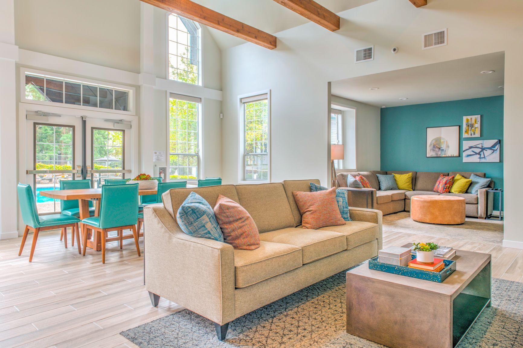 A living room with a couch , table and chairs.