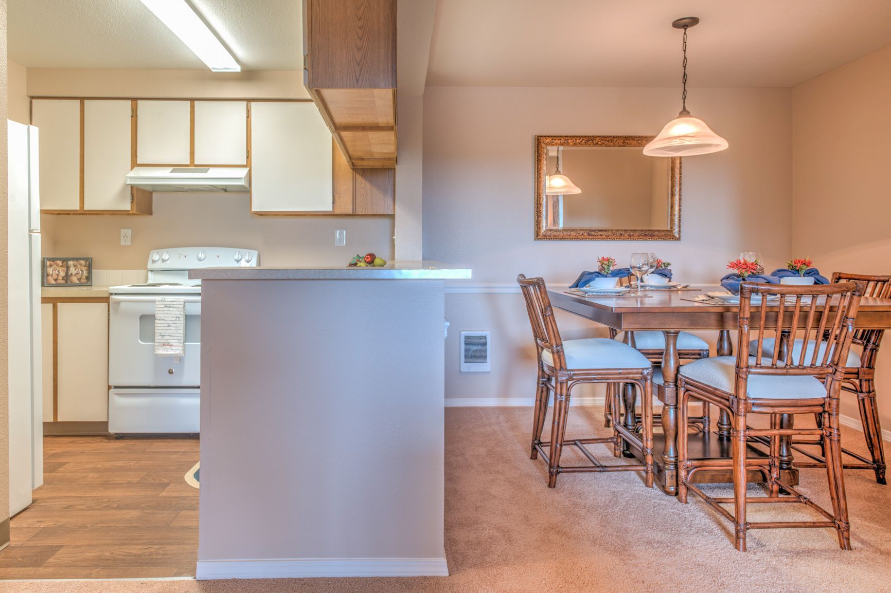 A kitchen and dining room with a table and chairs