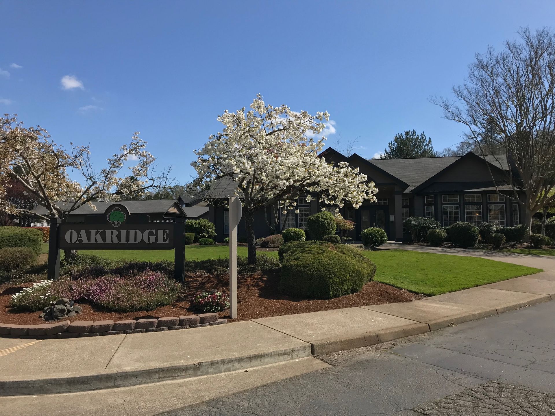 A house with a sign that says oakridge in front of it